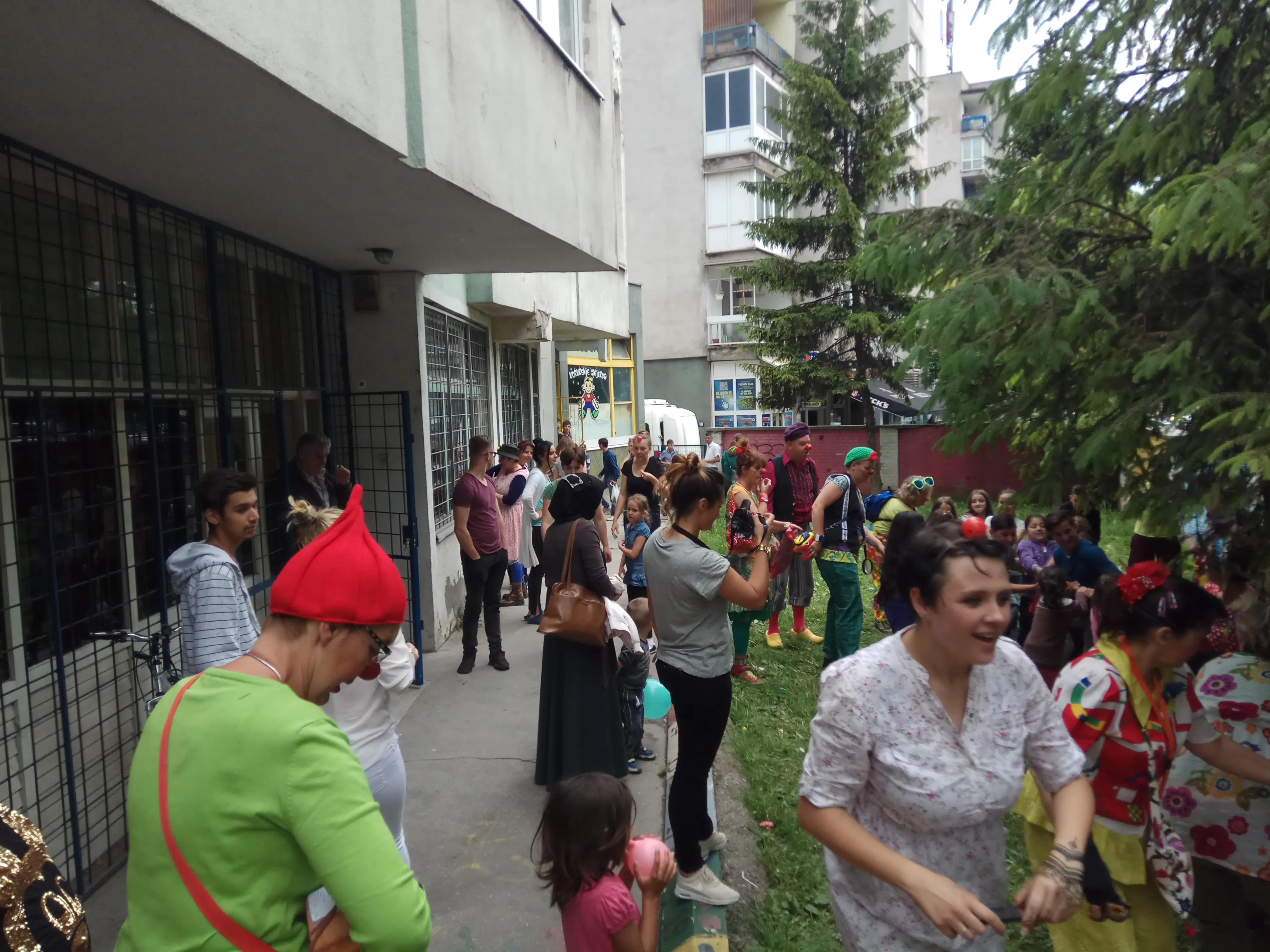 Children and volunteers outside the day center building