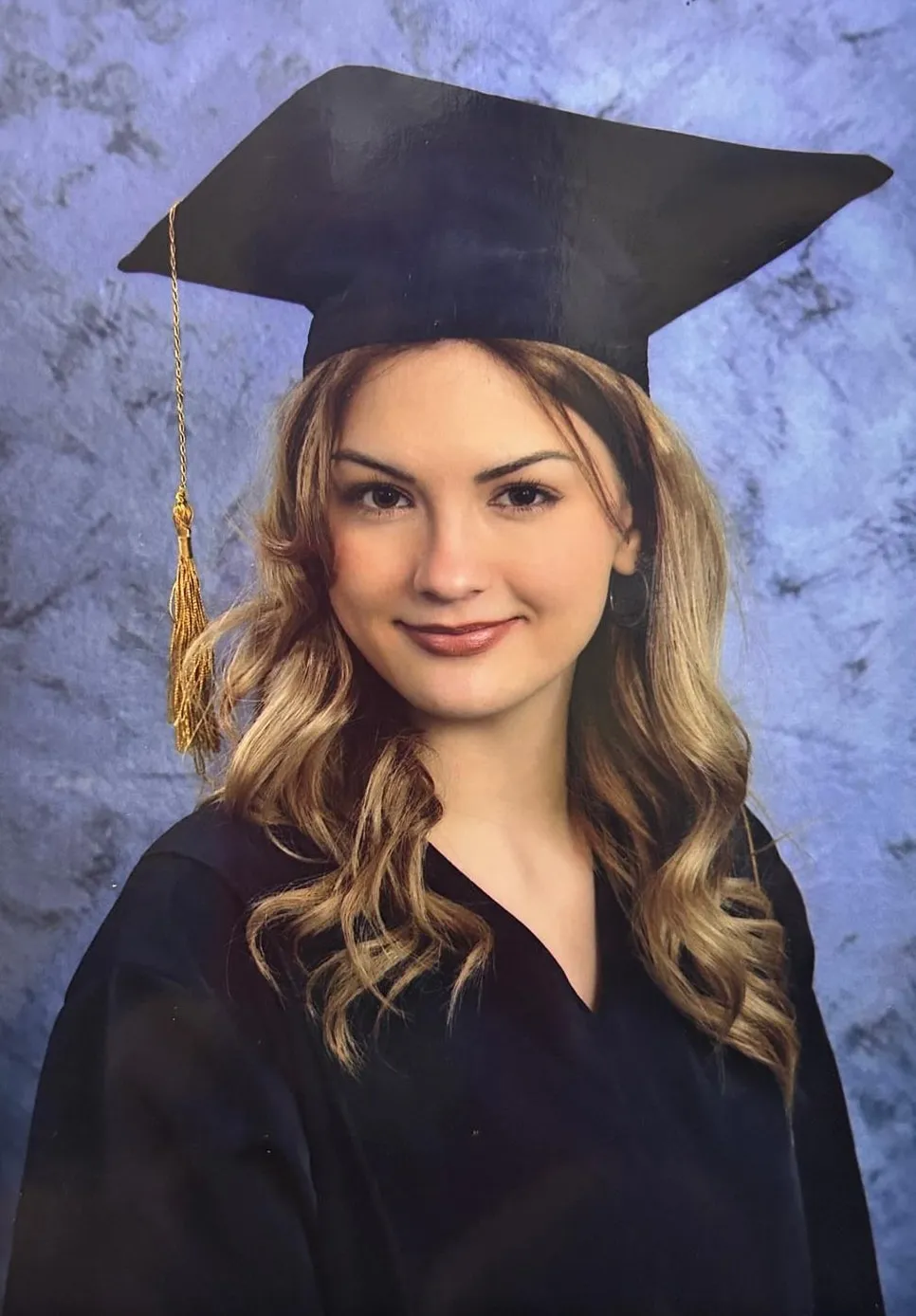 Ema, coordinator of the day center, in her graduation cap and gown