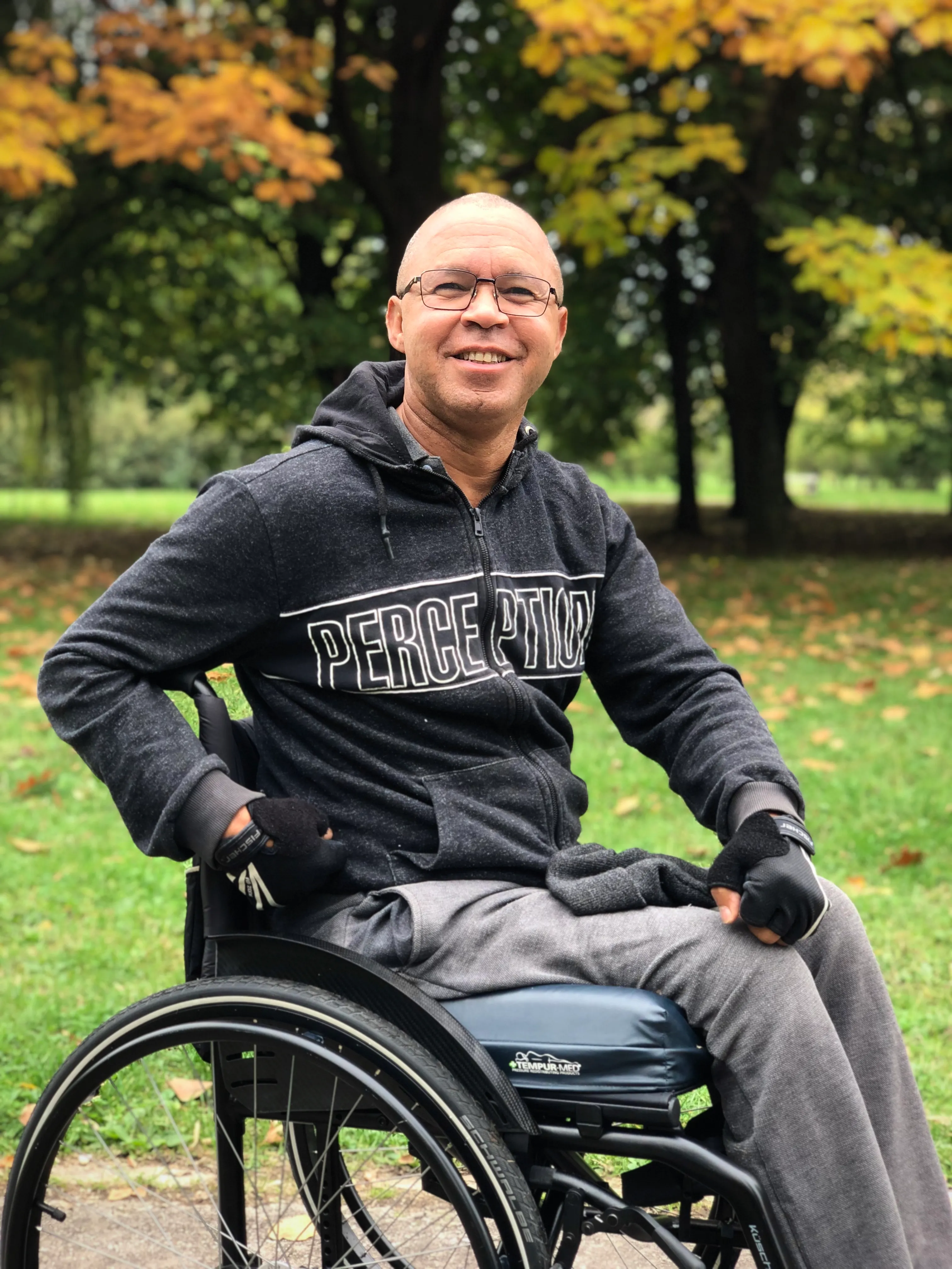 Walter Gonçalves, founder of Grace Valley, smiling in his wheelchair in a park